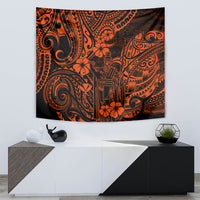 Orange and black Polynesian tapestry wall hanging featuring a central carved face and flowers