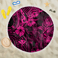 Pink round beach blanket with white fringe and bold Polynesian-style pattern