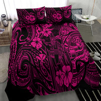 Pink and black Polynesian pattern bedding set draped over bed, full view