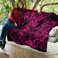 Pink Polynesian quilt held outdoors, with dark base and large floral swirl artwork