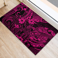 Pink and black rubber doormat with ornate Polynesian swirls and flower motif