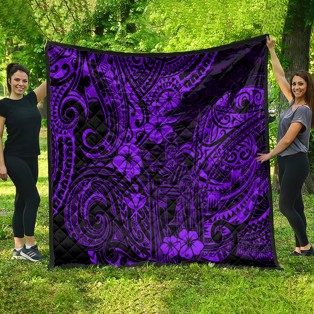 Purple and black Polynesian pattern quilt blanket spread outdoors