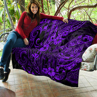 Purple and black Polynesian pattern quilt blanket draped on a couch