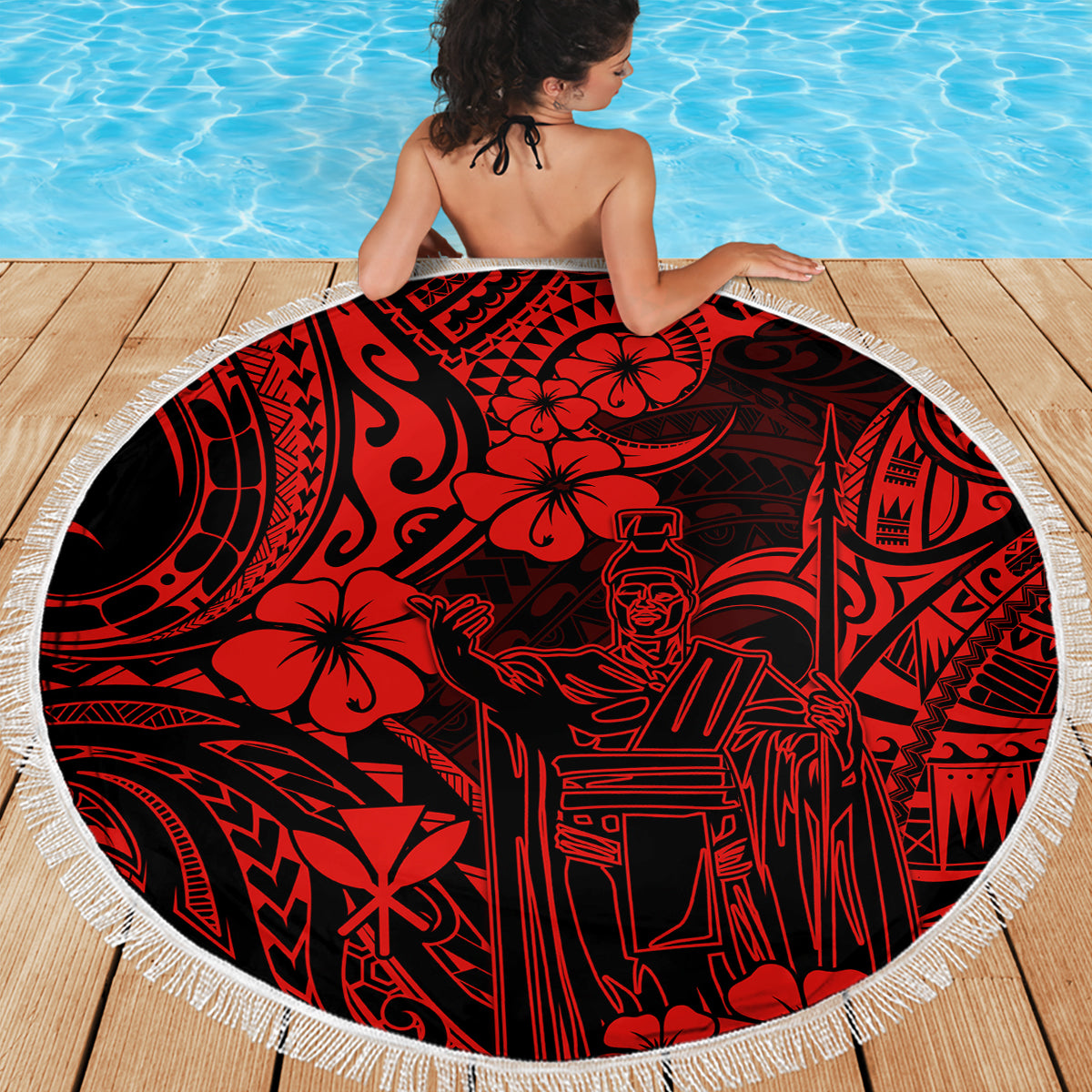 Red round beach blanket with Polynesian king Kamehameha illustration and white fringe