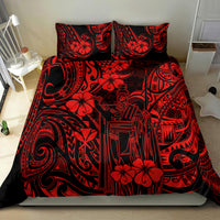 Red Polynesian patterned comforter and pillows on bed, straight-on view