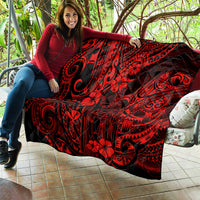Red Polynesian-pattern quilt with bold black swirls and floral motifs