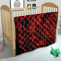 Red and black Polynesian pattern quilt with swirling designs