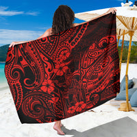 Red and black Polynesian patterned sarong with swirling tribal motifs, draped