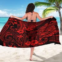 Red and black Polynesian sarong with bold tribal swirls and flower motifs