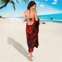 Red and black Polynesian sarong wrap skirt with dark tribal print and floral motifs