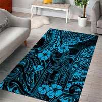 Rectangular blue area rug with bold Polynesian tribal motifs and flower details