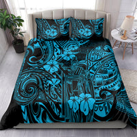 Polynesian patterned bedding set comforter and pillowcases in blue and black on a bed