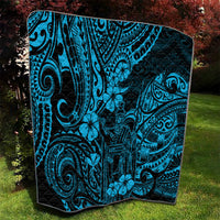 Blue Polynesian pattern quilt square with tiki figures, swirls, and dark edging.