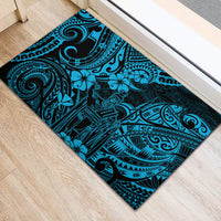 Rectangular blue rubber doormat with Polynesian tiki-inspired tribal swirl pattern.