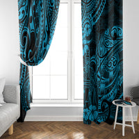 Blue Polynesian pattern window curtains hanging on a doorway with matching panels