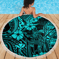 Turquoise round beach blanket with Polynesian illustration pattern and white fringe