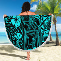 Turquoise round beach blanket with Polynesian pattern, held open on sunny beach
