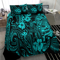 Turquoise and black Polynesian tribal patterned comforter on bed