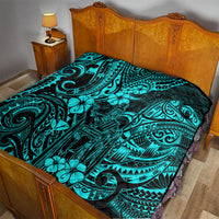 Turquoise Polynesian pattern quilt on bedspread over a wooden bed frame
