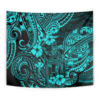 Turquoise Polynesian pattern tapestry close-up with tiki figure and swirl ornaments