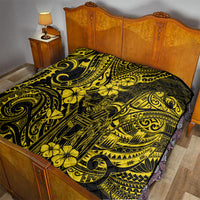 Yellow-and-black Polynesian pattern quilt spread across a wooden bed