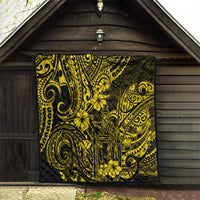 Yellow-and-black Polynesian pattern quilt hanging on a wooden wall