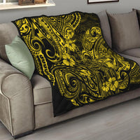 Yellow-and-black Polynesian pattern quilt folded on a living room sofa