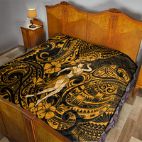 Gold and black Polynesian hula girl quilt neatly laid on a bed with large swirling patterns