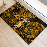 Gold and black rubber doormat featuring seated hula girl amid tribal swirl patterns