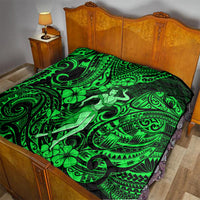 Green and black Polynesian hula girl quilt laid on a bed with swirling tribal designs