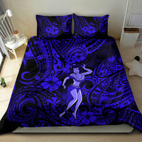 Navy blue hula girl bedding set on bed with ornate swirl, tiki shapes, and flowers