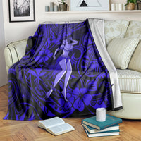 Navy blue Polynesian hula girl blanket draped on a sofa with books nearby
