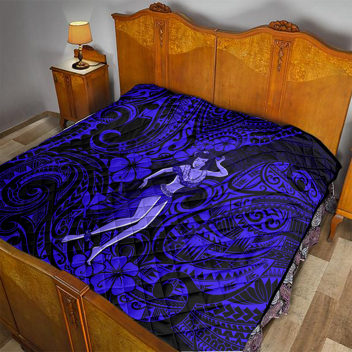 Hula girl quilt on bed, navy and royal blue tribal swirl and hibiscus floral print