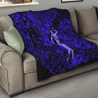 Navy blue hula girl quilt on sofa, black-and-blue swirls with hibiscus flowers