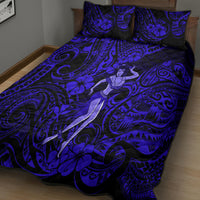 Navy quilt bed set with hula girl motif and swirl floral pattern, shown on bed surface