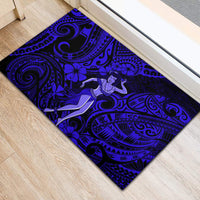 Blue rubber doormat with central hula dancer, tiki flowers, and spiral motifs