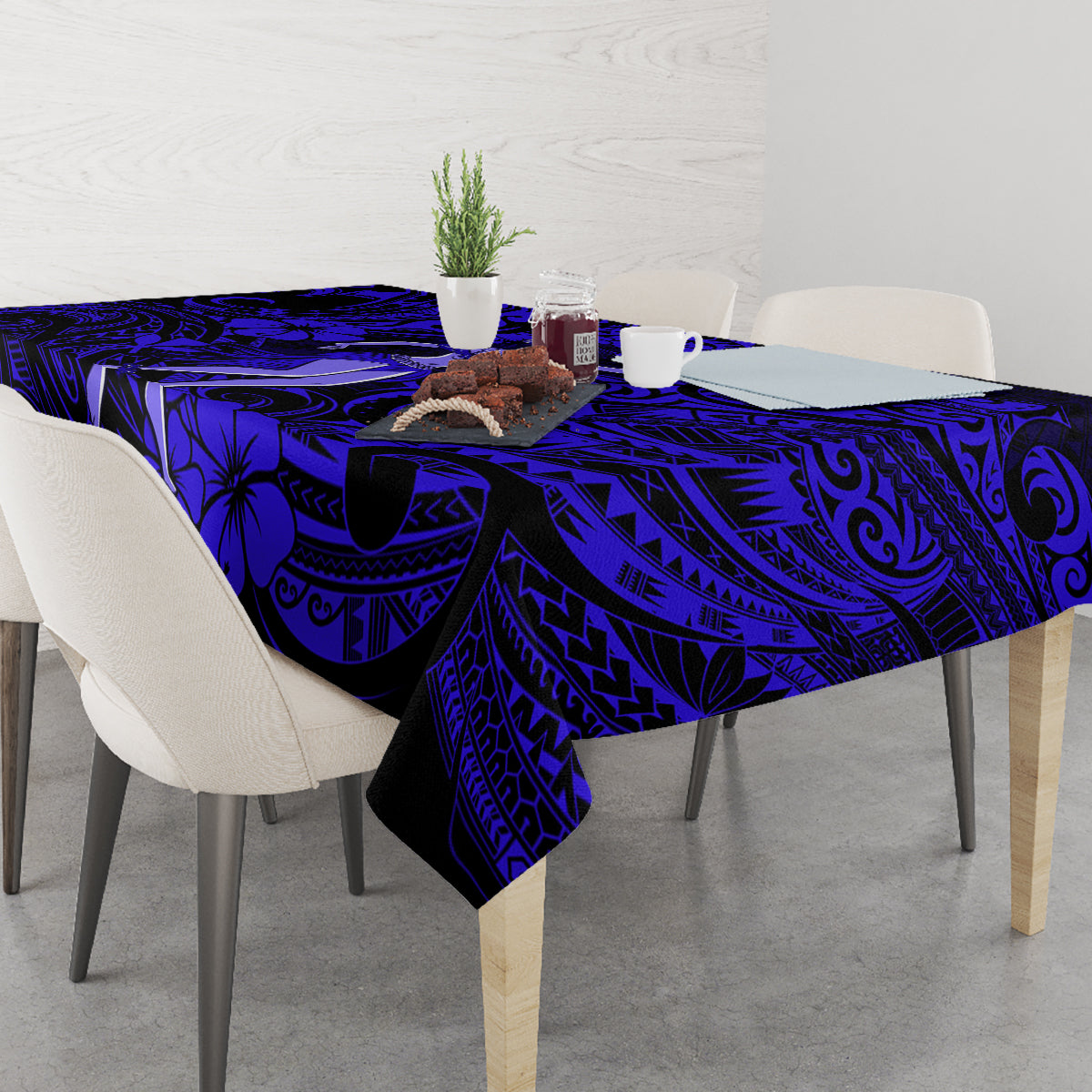 Navy blue tablecloth with Polynesian swirl and palm motif pattern on dining table
