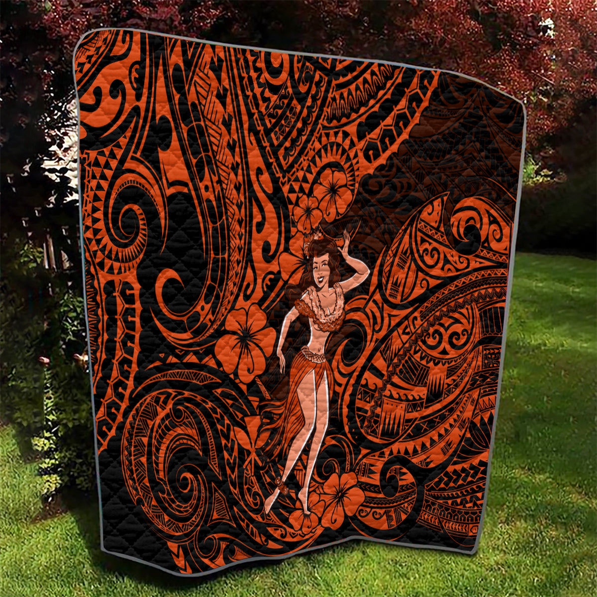 Orange and black Polynesian hula girl quilt with hibiscus motifs and swirls
