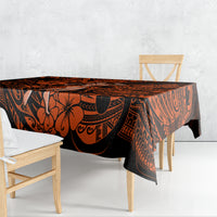 Orange and black Polynesian pattern tablecloth draped over rectangular table