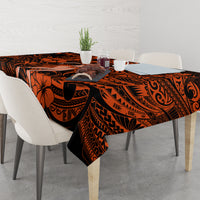 Orange and black Polynesian floral and tribal tablecloth covering dining table
