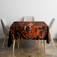 Orange and black Polynesian patterned tablecloth on dining table with chairs