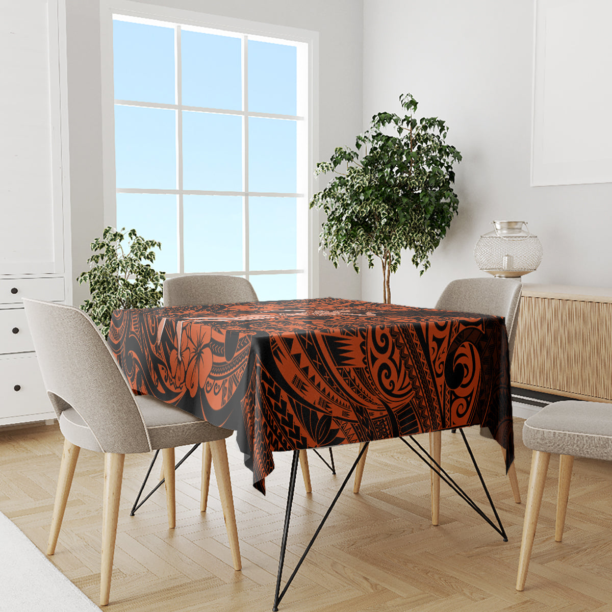 Orange and black Polynesian tablecloth on dining table with beige chair backs
