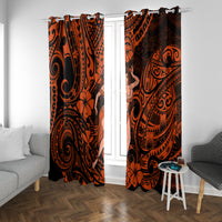 Two orange and black patterned window curtains with hula girl medallion on each panel