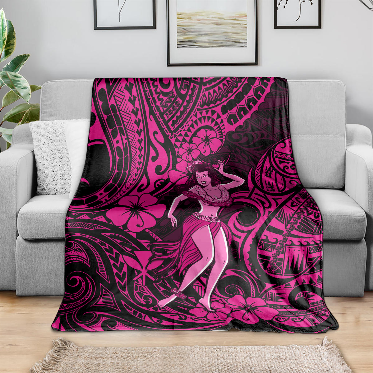 Pink and black hula girl blanket draped on couch, with polynesian swirls and flowers