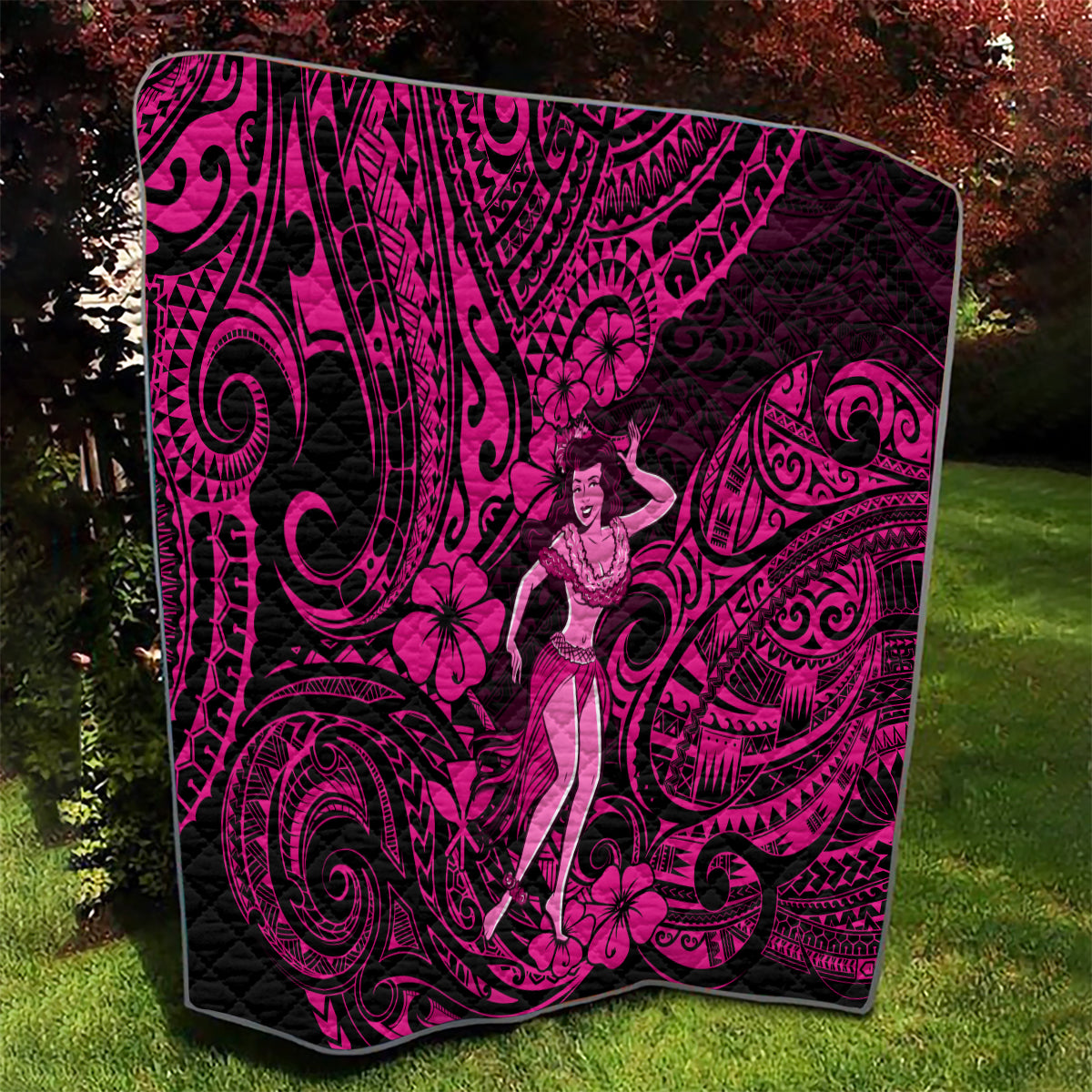 Pink and black Polynesian hula girl quilt outdoors with large swirling pattern details