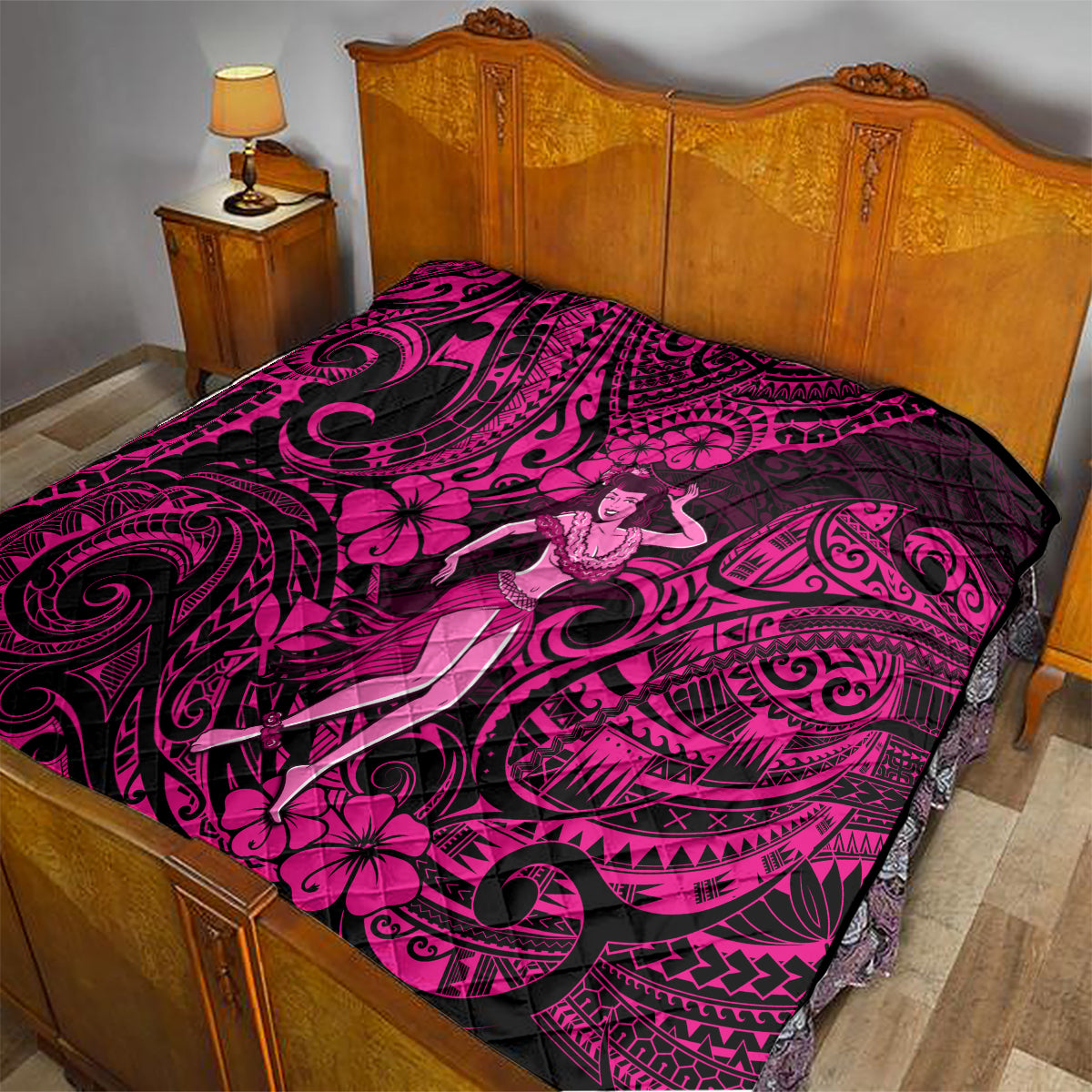 Pink and black Polynesian hula girl quilt laid on bed, showing swirling tribal design