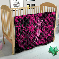 Pink and black Polynesian hula girl quilt on a baby bed, bold swirling motif design