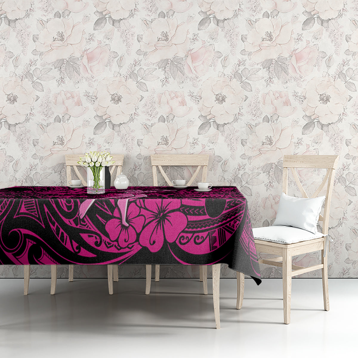 Pink and black Polynesian tablecloth with floral and tribal motif on table top
