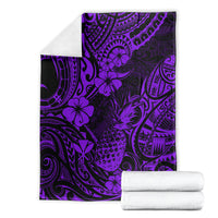 Purple Polynesian pineapple pattern blanket shown with folded white towels