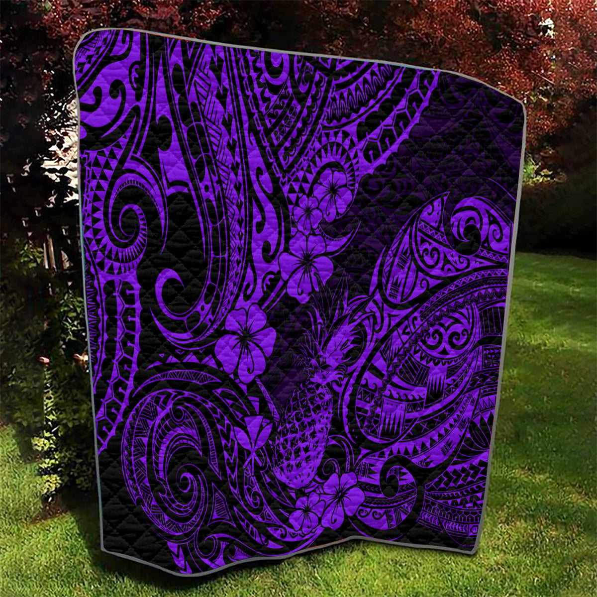 Purple Polynesian quilt with black background, ornate swirls and pineapple flower motifs